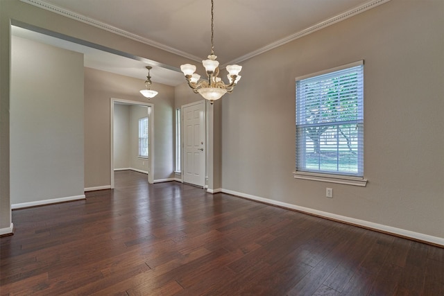 unfurnished room featuring crown molding, dark wood-type flooring, and a chandelier