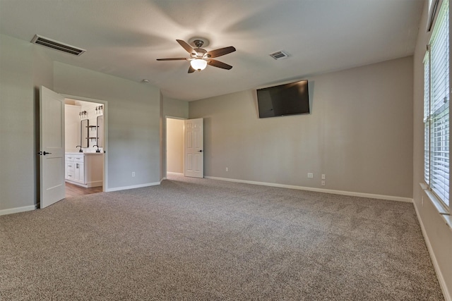 unfurnished bedroom featuring ceiling fan and light colored carpet