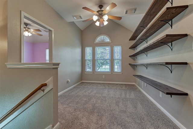 carpeted empty room with ceiling fan and vaulted ceiling