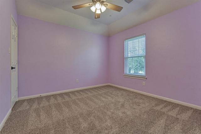 carpeted spare room featuring ceiling fan and lofted ceiling