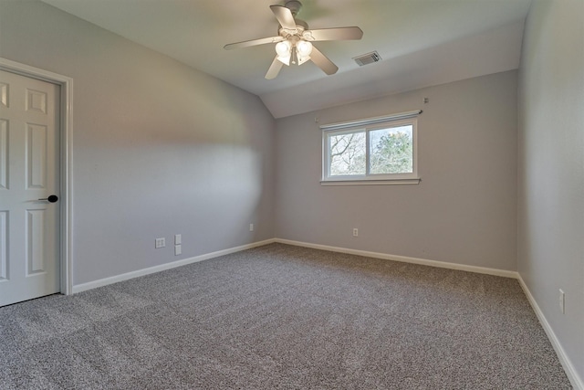 carpeted empty room featuring vaulted ceiling and ceiling fan