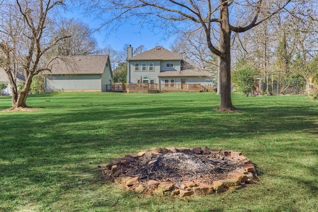 view of yard with a fire pit and a deck