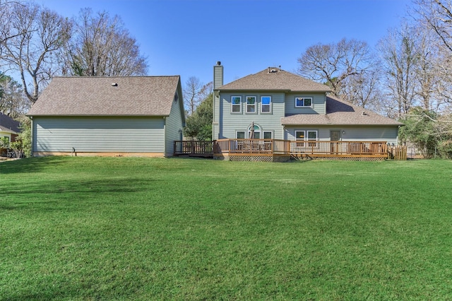 back of house featuring a yard and a wooden deck