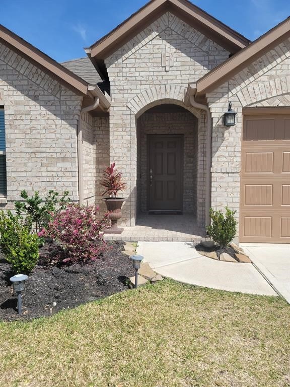 view of exterior entry with a garage