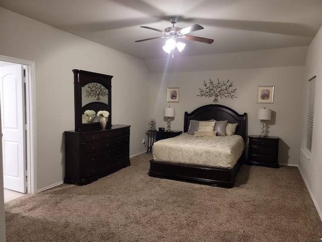 carpeted bedroom featuring ceiling fan and vaulted ceiling