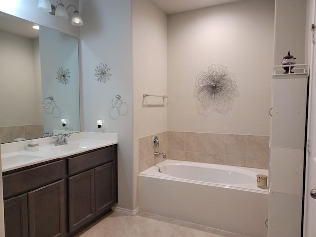 bathroom featuring a tub to relax in, tile patterned flooring, and vanity