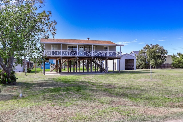 back of house with an outdoor structure, a yard, and a porch