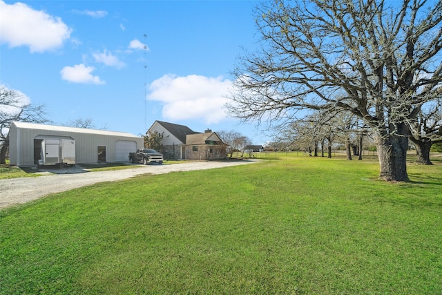 view of yard featuring an outbuilding and a garage