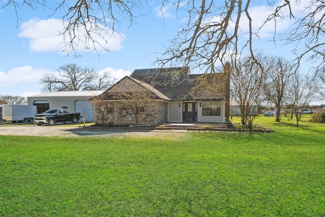 view of front of property with a garage and a front lawn