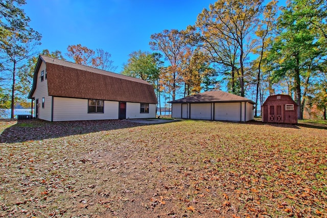 view of side of home with a garage and a storage unit