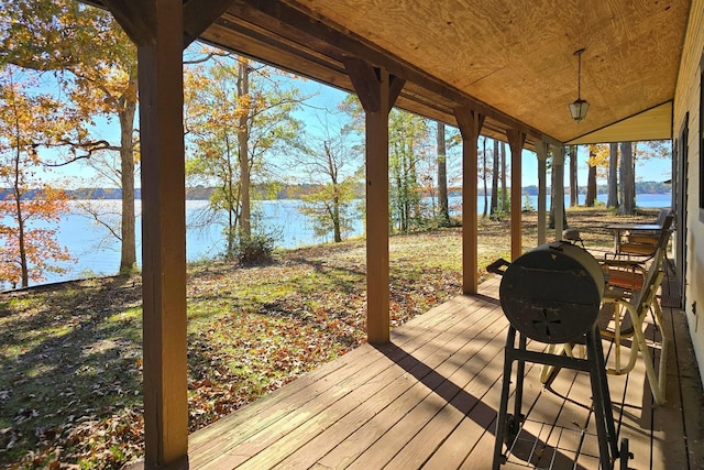 wooden terrace featuring a water view