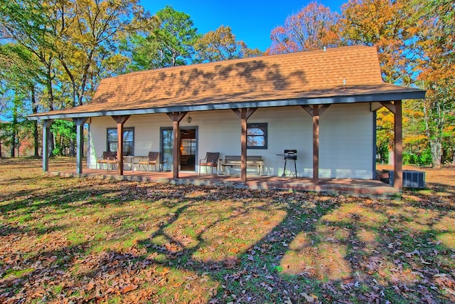 back of house with a yard and a patio