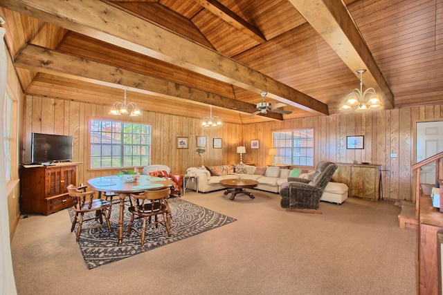 dining space with carpet, ceiling fan with notable chandelier, wood ceiling, and wooden walls