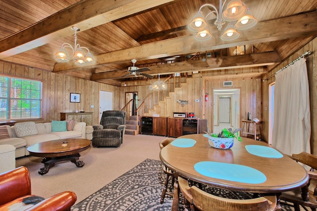 dining room featuring wood walls, wooden ceiling, and ceiling fan with notable chandelier