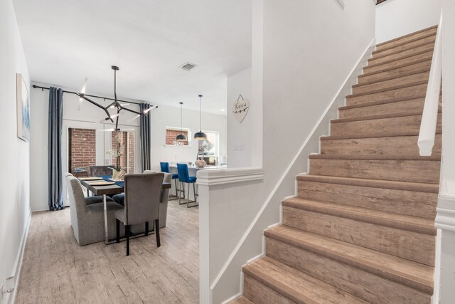 dining space featuring a chandelier and light hardwood / wood-style floors