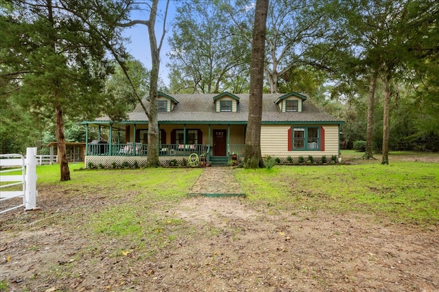 cape cod house with a porch and a front lawn