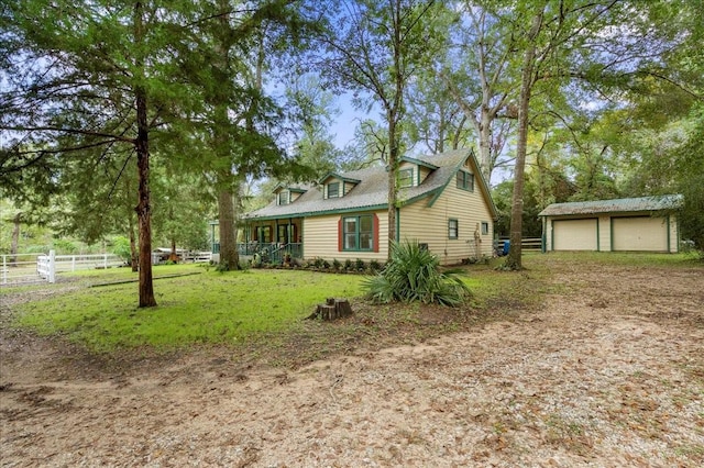 view of side of home with a garage, an outdoor structure, and a lawn