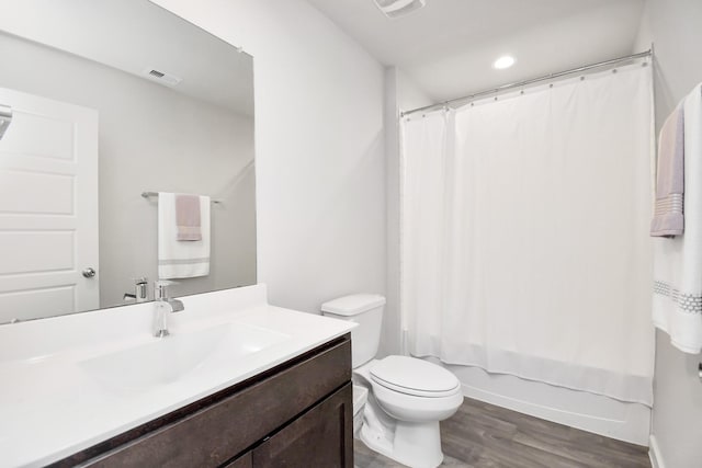 full bathroom with vanity, toilet, wood-type flooring, and shower / bath combo with shower curtain