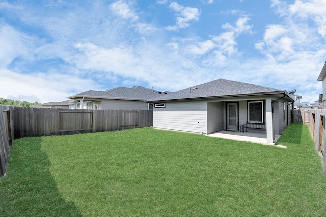 back of house with a lawn and a patio area