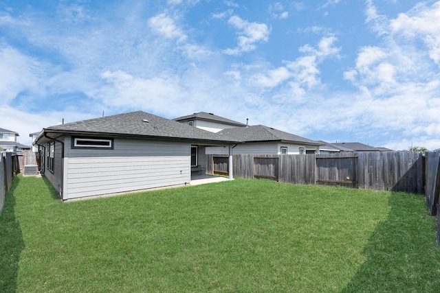 rear view of property with a lawn and a patio area