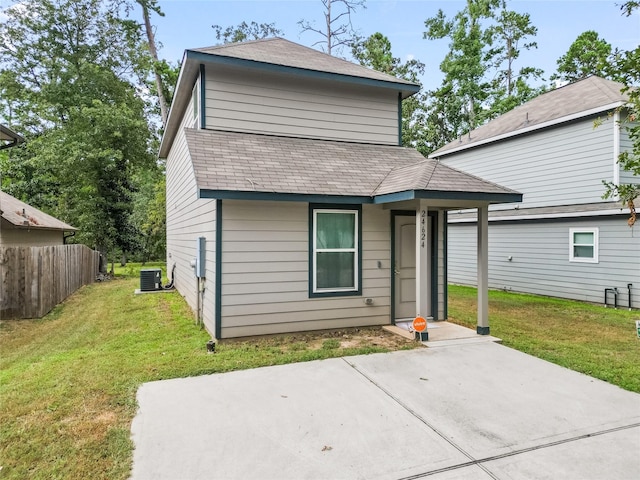 view of front of home with a patio and a front lawn