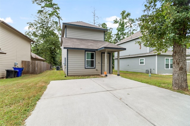 view of front of home with cooling unit and a front lawn