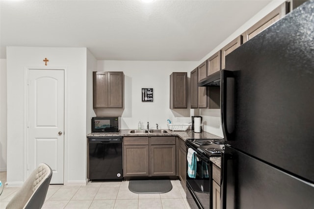 kitchen with light tile patterned floors, sink, dark stone counters, and black appliances