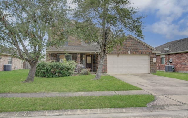 view of front of home with a front yard, a garage, and central air condition unit