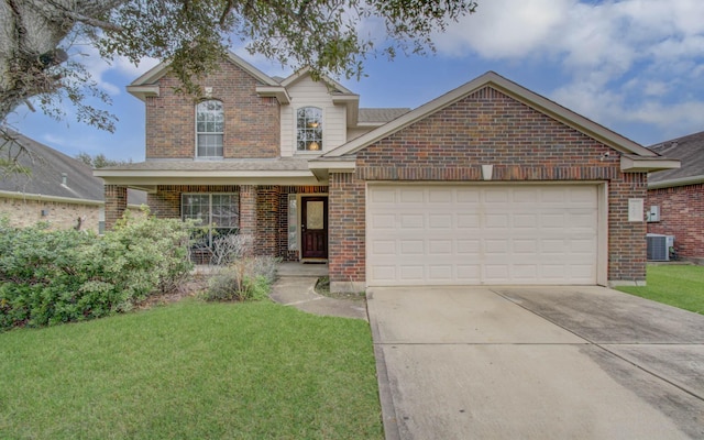 front facade featuring a front yard, a garage, and central air condition unit