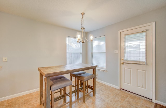 dining area featuring an inviting chandelier