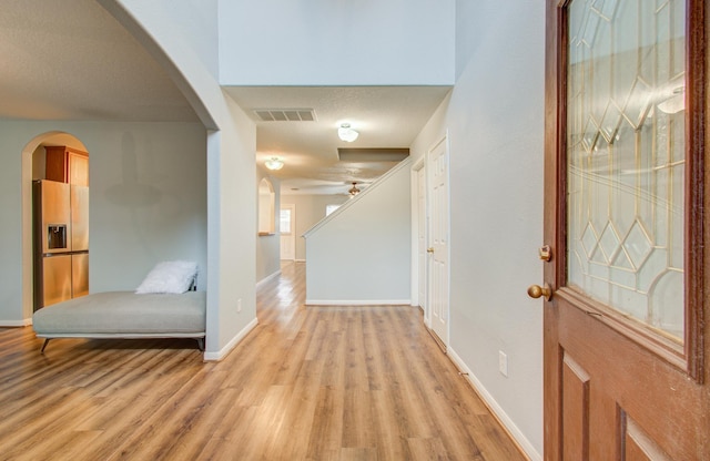 foyer entrance with ceiling fan and light hardwood / wood-style flooring