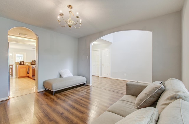 living room with a chandelier and wood-type flooring