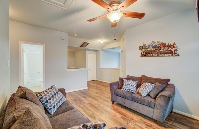 living room featuring ceiling fan and hardwood / wood-style floors