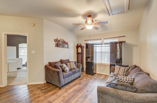 living room featuring a wealth of natural light, ceiling fan, and wood-type flooring