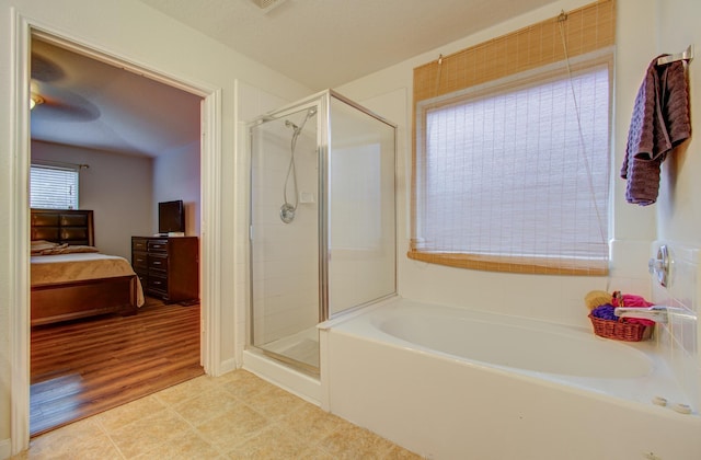 bathroom featuring shower with separate bathtub and hardwood / wood-style flooring