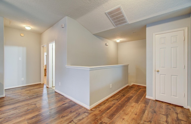 interior space with dark hardwood / wood-style flooring and a textured ceiling