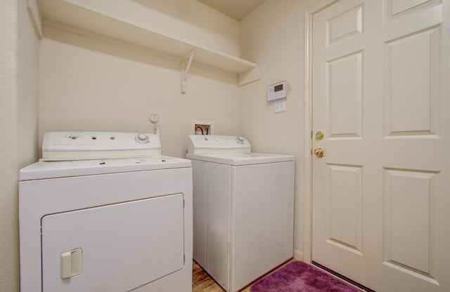 clothes washing area with washing machine and clothes dryer