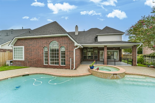 view of swimming pool featuring a patio area and an in ground hot tub