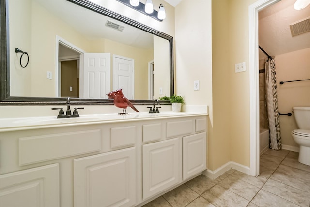 full bathroom with tile patterned flooring, vanity, toilet, and shower / bath combo with shower curtain