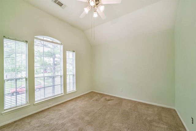 carpeted spare room with ceiling fan and lofted ceiling