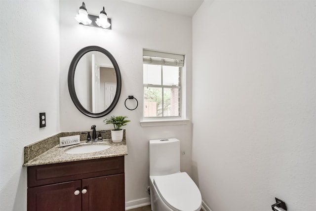 bathroom with vanity and toilet