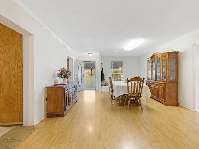 dining area featuring crown molding and light hardwood / wood-style floors