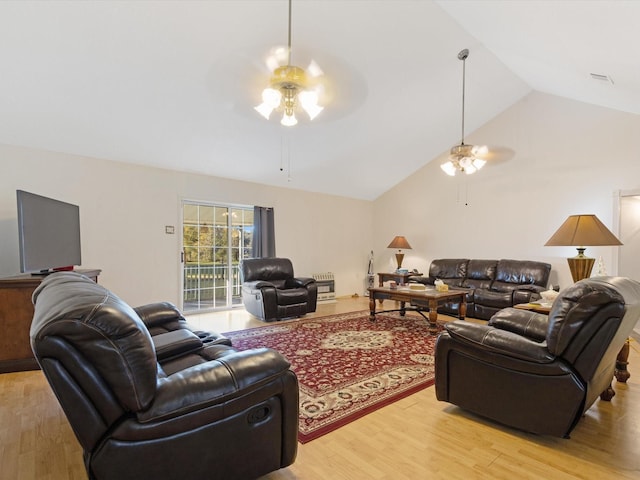 living room featuring light hardwood / wood-style flooring, ceiling fan, and lofted ceiling