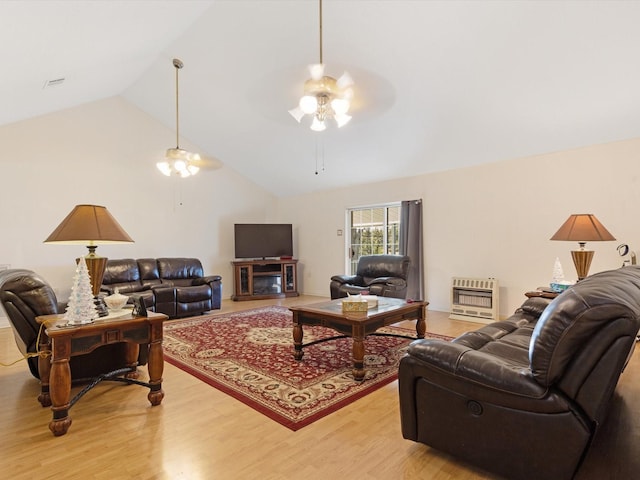 living room with ceiling fan, light hardwood / wood-style floors, vaulted ceiling, and heating unit