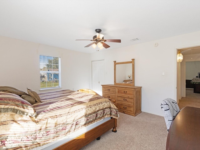 bedroom with ceiling fan and light colored carpet