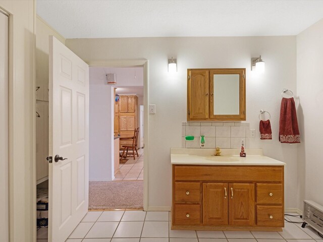 bathroom featuring tile patterned floors, decorative backsplash, and vanity