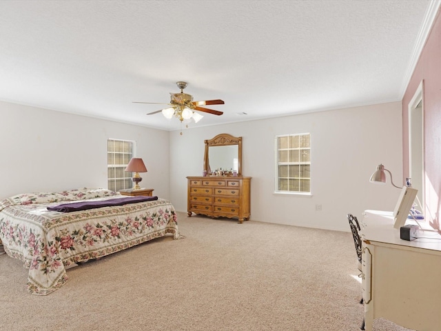 bedroom with ceiling fan, light colored carpet, a textured ceiling, and ornamental molding