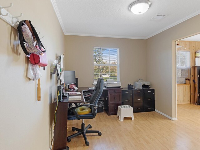 office space featuring crown molding, light hardwood / wood-style flooring, and a textured ceiling