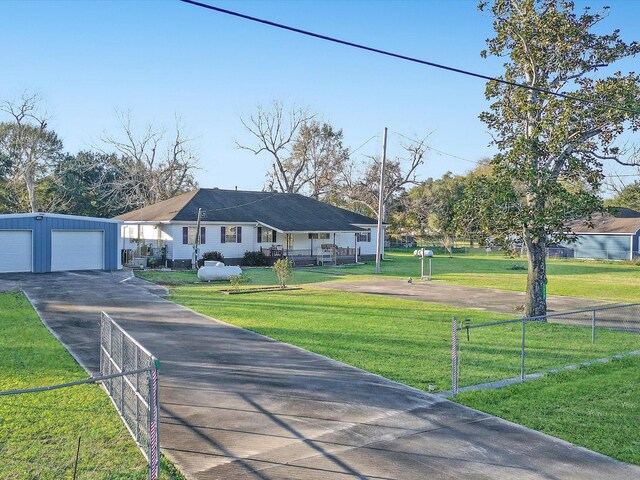 ranch-style home featuring a garage, an outdoor structure, and a front yard