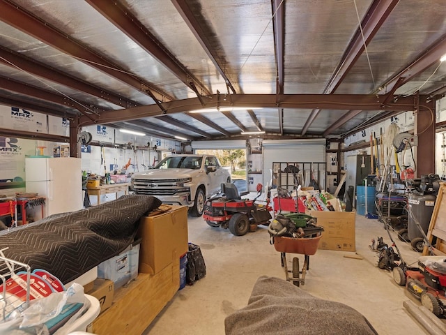 garage featuring a workshop area and white refrigerator